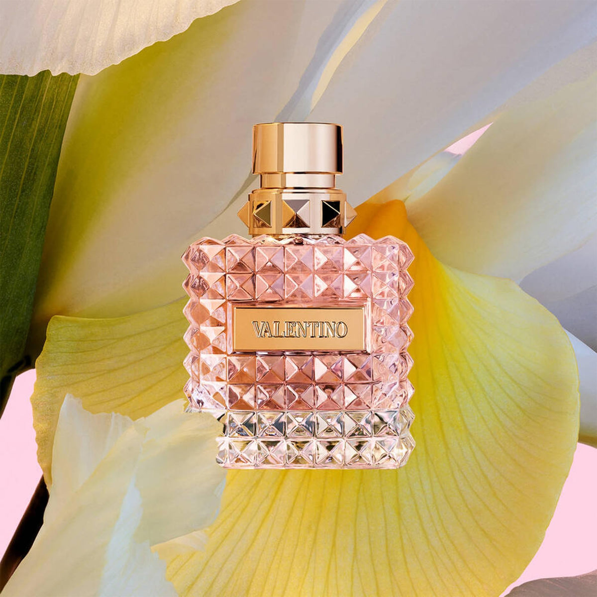 Valentino Donna Eau De Parfum bottle with soft floral background