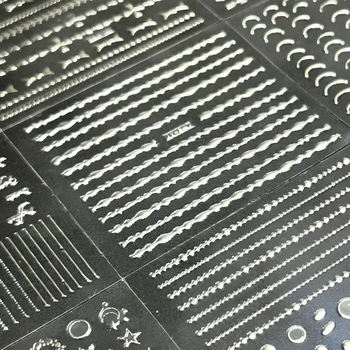 Variety of SPLOCUDU silver nail art stickers displayed