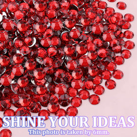 Variety of TINKRSTUFF red rhinestones displayed on a table