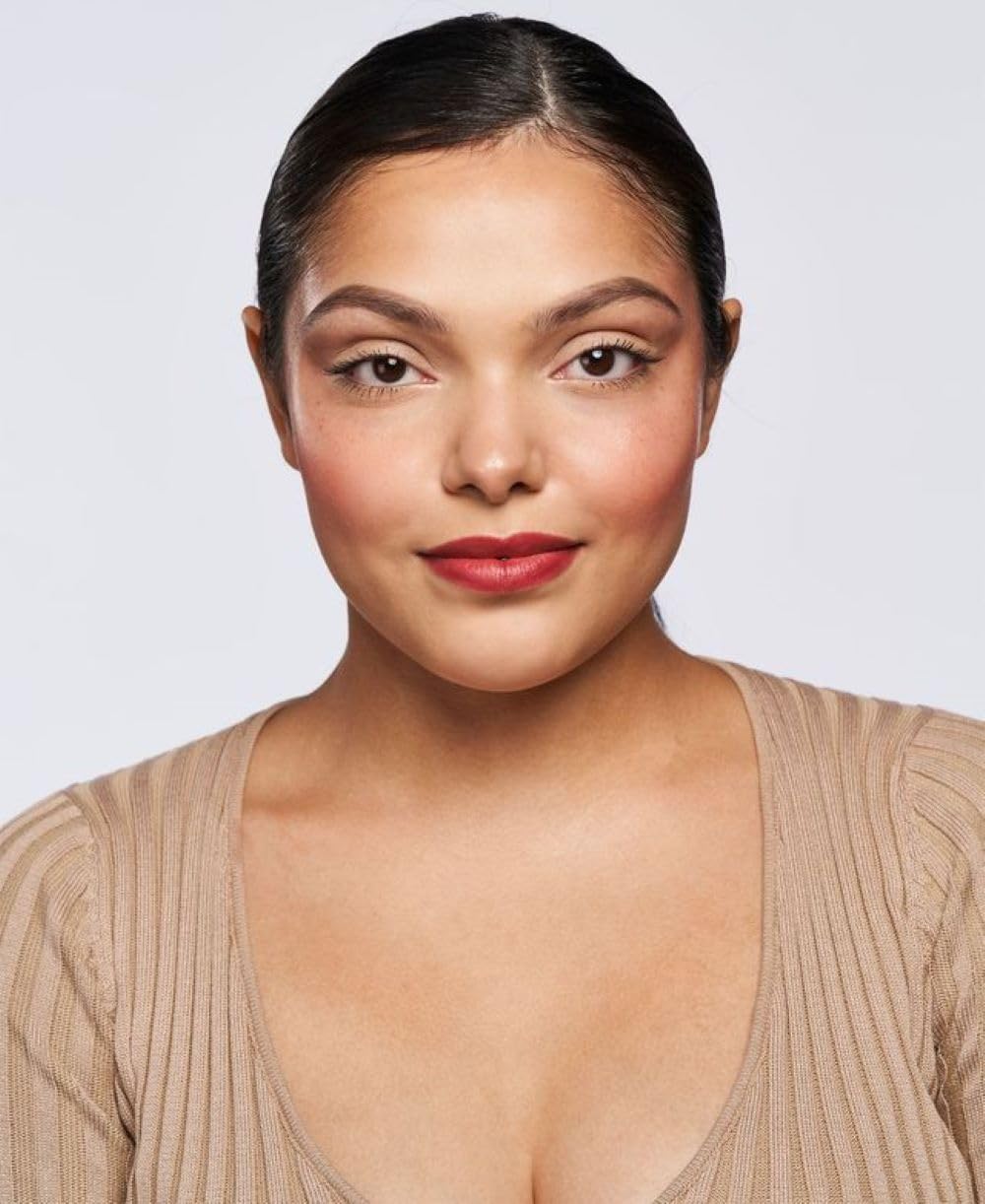 Wander Beauty On-the-Glow Blush Stick applied on cheeks for a natural look