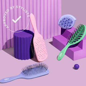 Wet Brush Go Green Mini Detangler on a bathroom counter