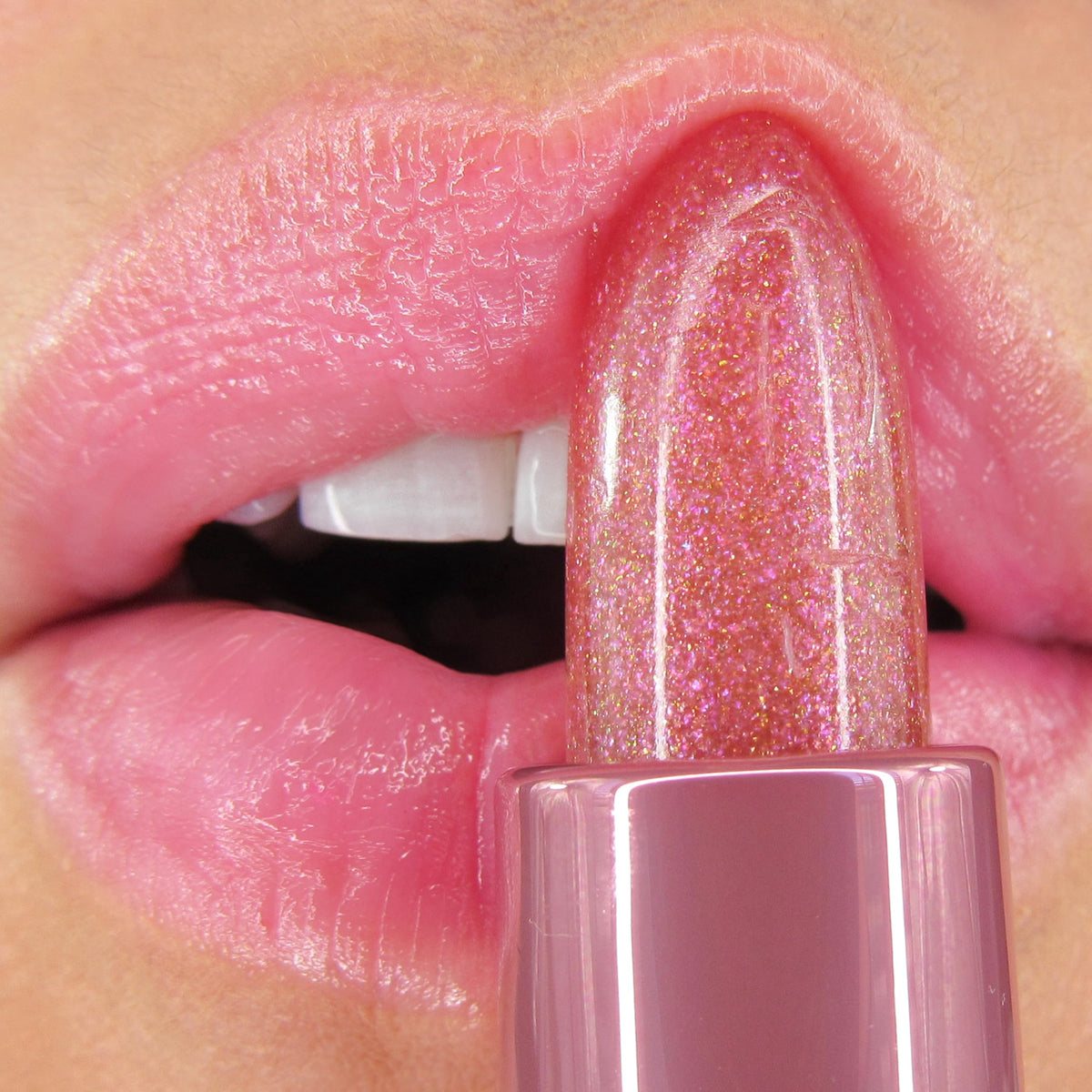 Winky Lux Pink Opal Glimmer Balm displayed with raspberry and vanilla