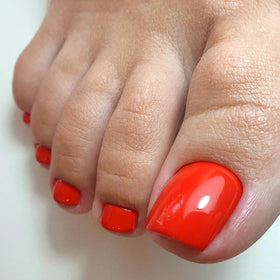 Woman applying LuckForever press on toenails at home