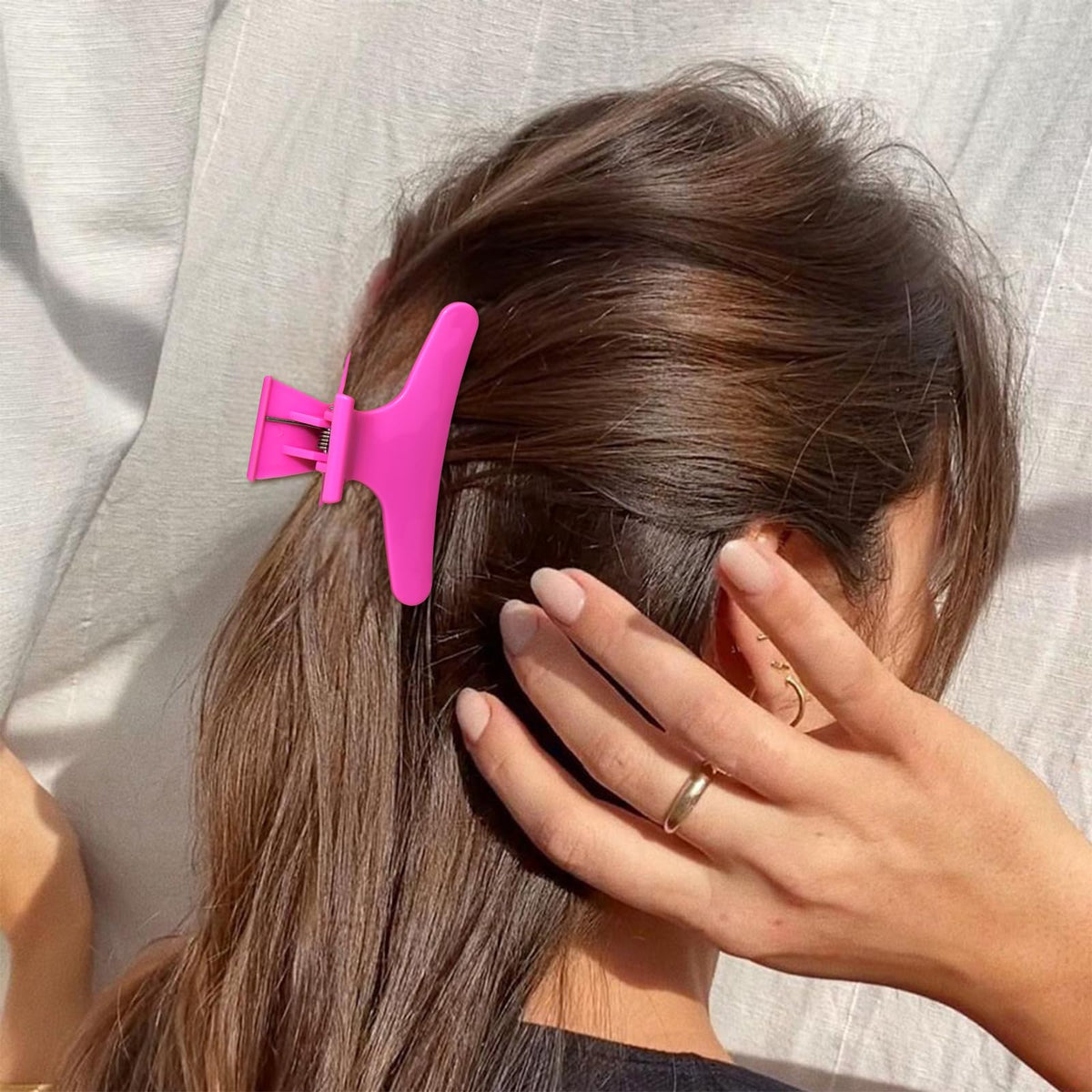 Woman using Ondder Butterfly Hair Claw Clips while styling hair