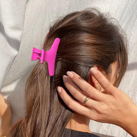 Woman using Ondder Butterfly Hair Claw Clips while styling hair