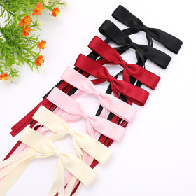 WORTL hair bows in red and pink on a table