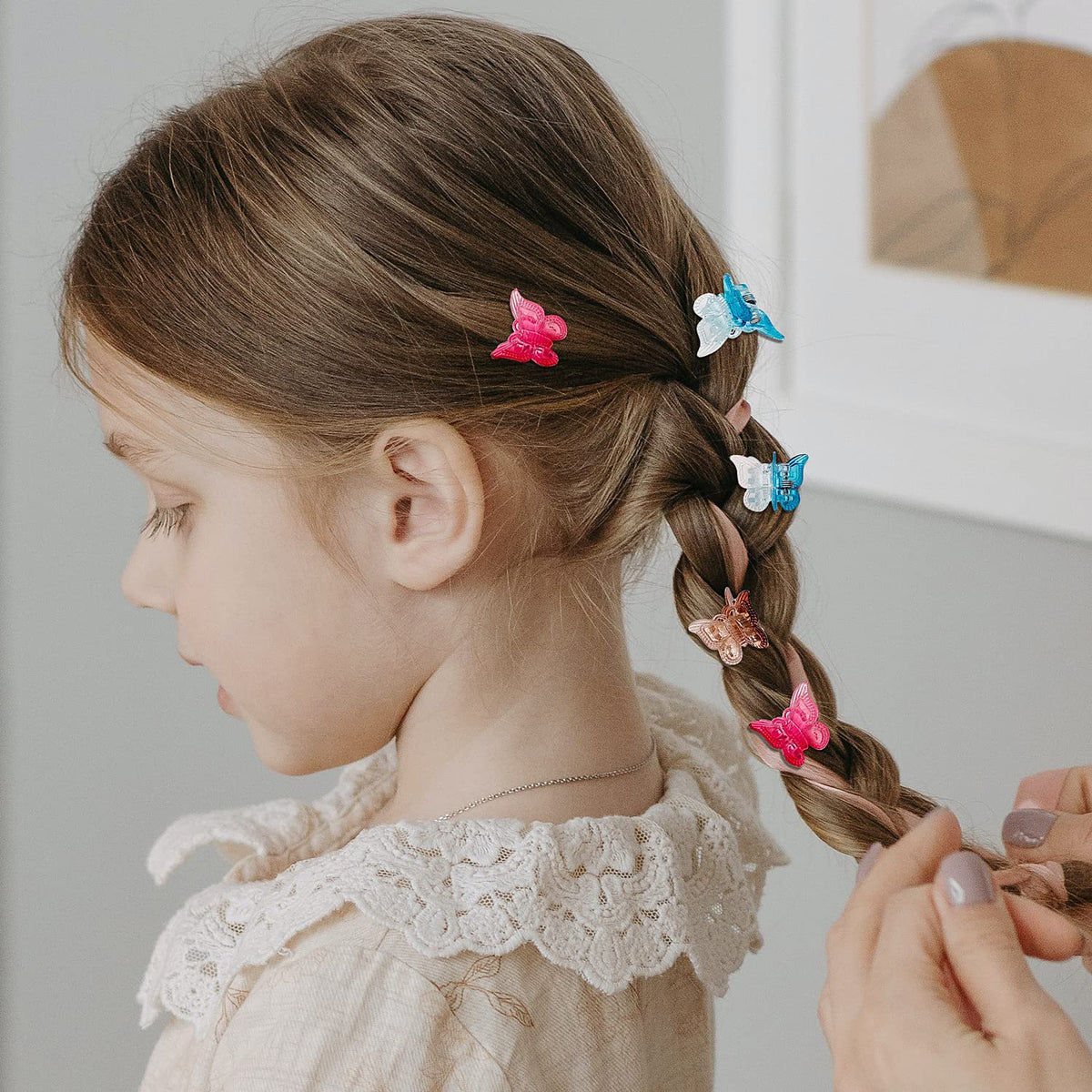 XIEHE butterfly hair clips in a plastic storage container