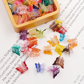 XIEHE butterfly hair clips showing size comparison in hand